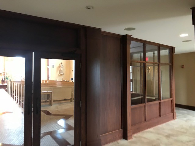 Church welcome center desk with warm wood veneer millwork (portfolio image 5)