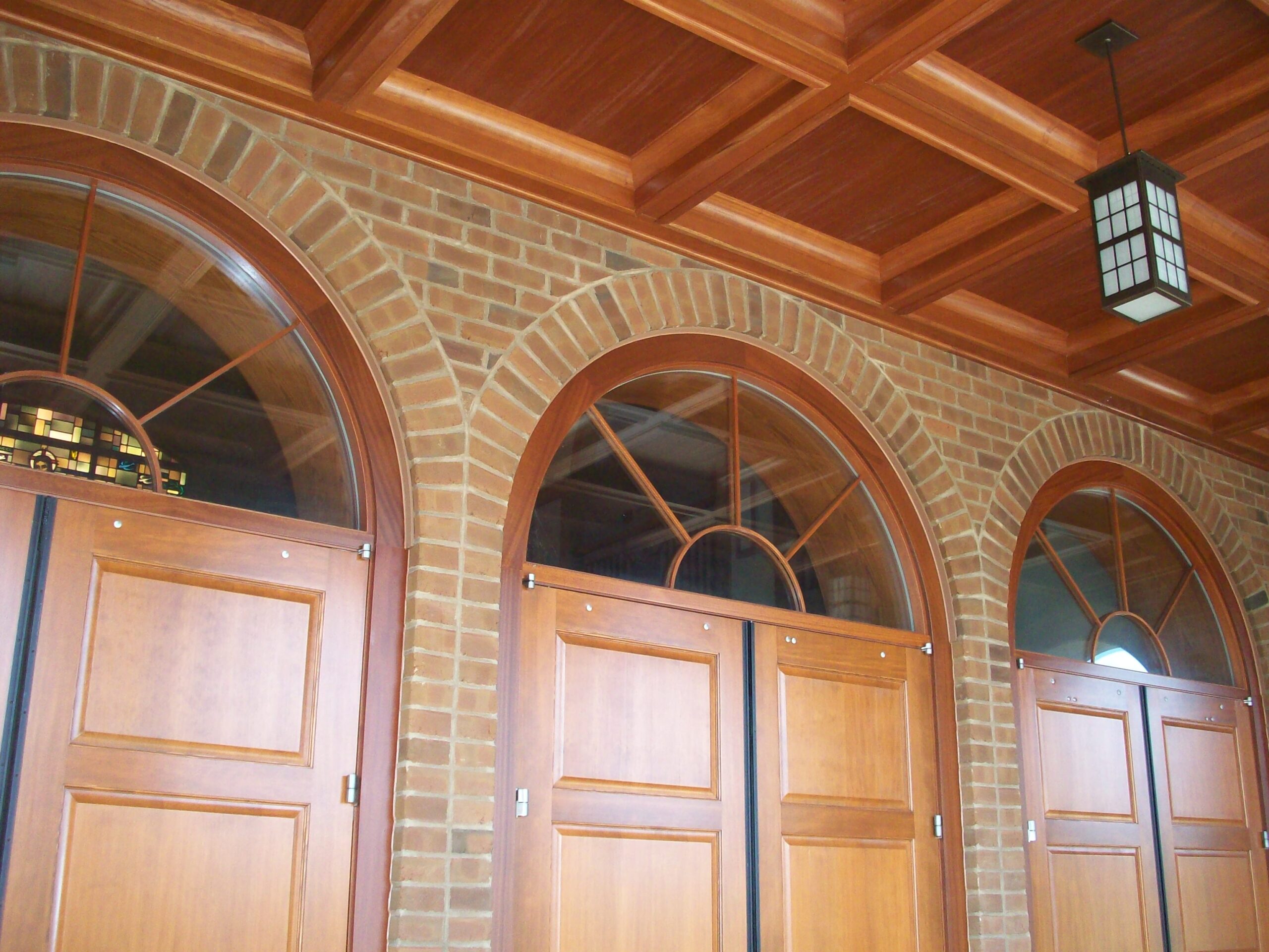 Church welcome center desk with warm wood veneer millwork (portfolio image 9)