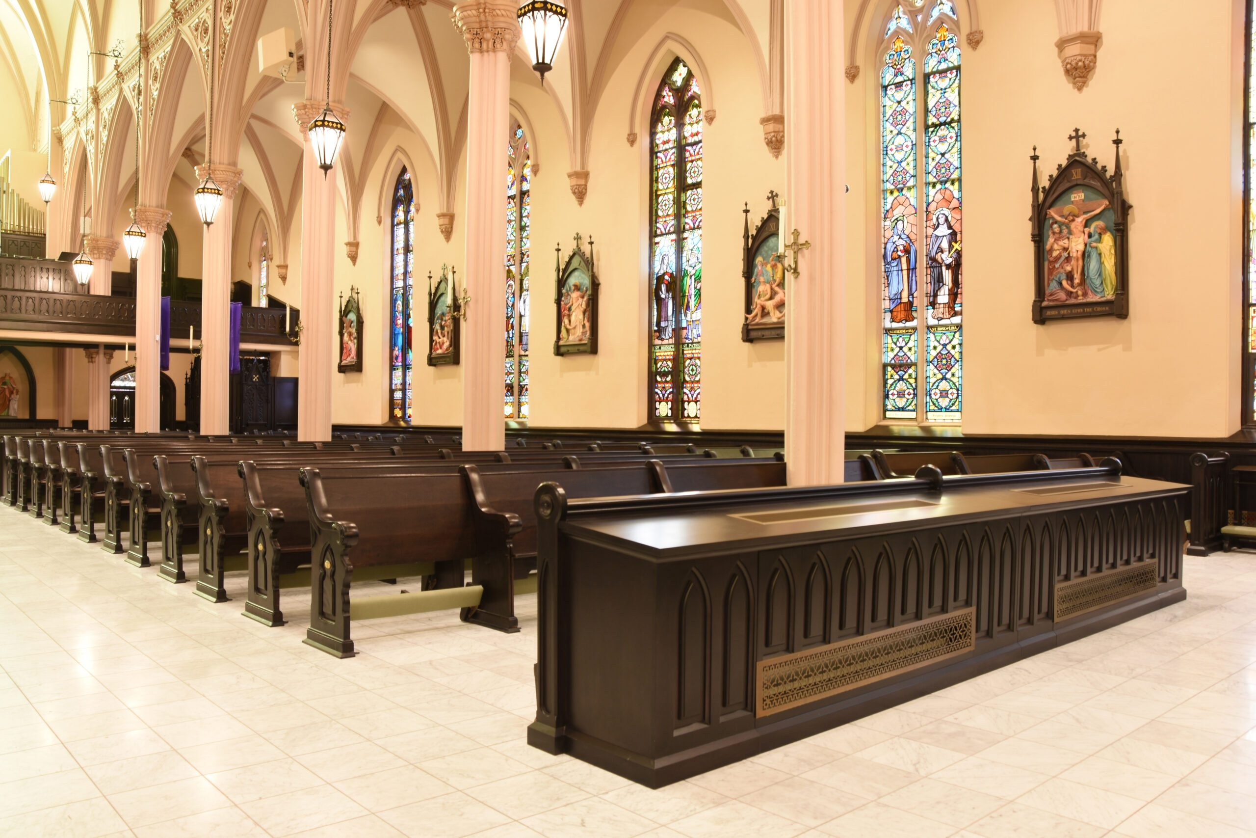 Church welcome center desk with warm wood veneer millwork used as the churches page hero image
